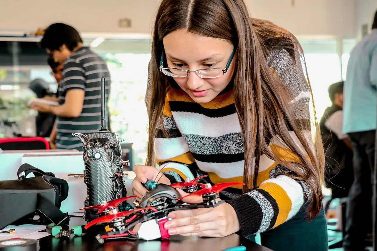 A competitor working on a racing drone at a preparation table during LASIRS.
